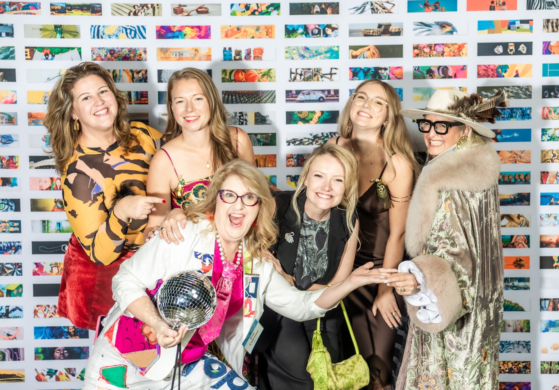 Kristi and fellow ArtPop attendees laughing and posing with a disco-ball bag and expressive eveningwear