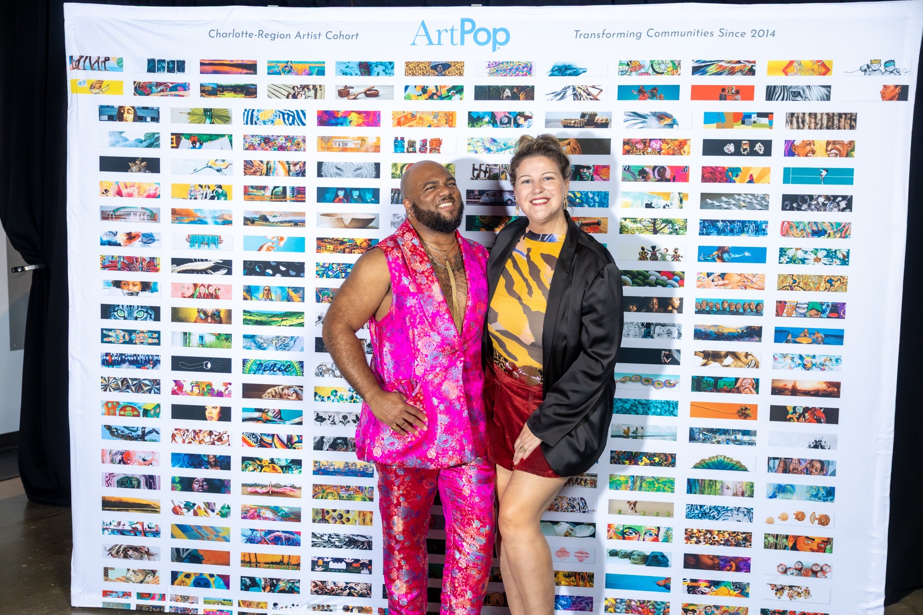 Darrell Anderson in a bright pink suit with Kristi Straw at ArtPop’s 2026 Upcycled Fashion Show